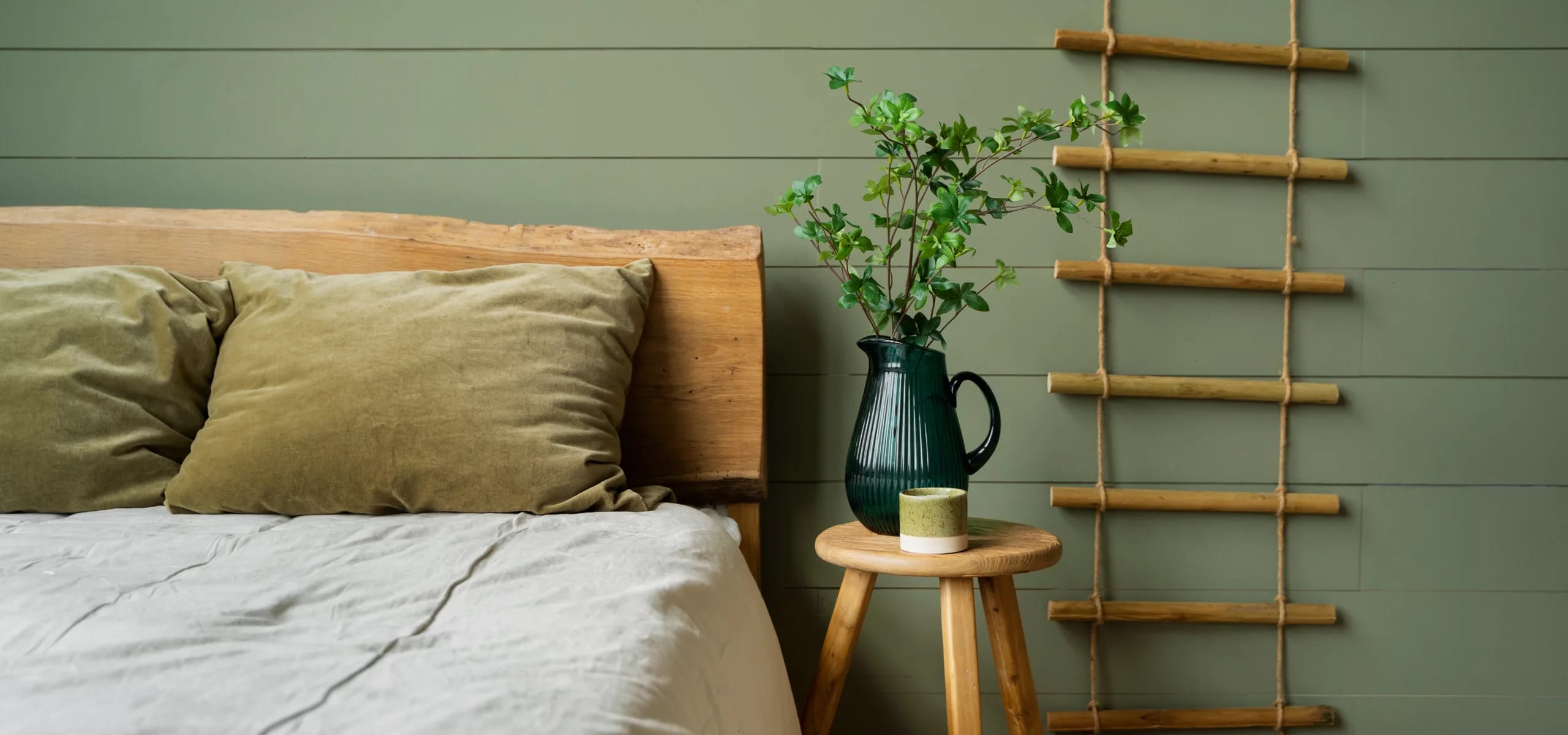 A Club Material Studio bedroom in a soft green finish